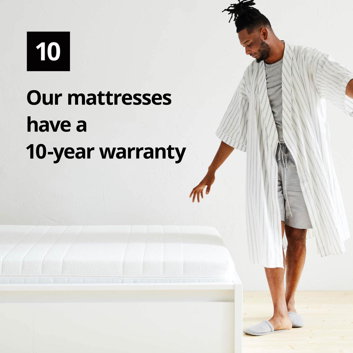 A man in a bathrobe stands next to a mattress and a graphic symbol with the number 10 and the text "Our mattresses have a 10-year limited warranty" on the image.