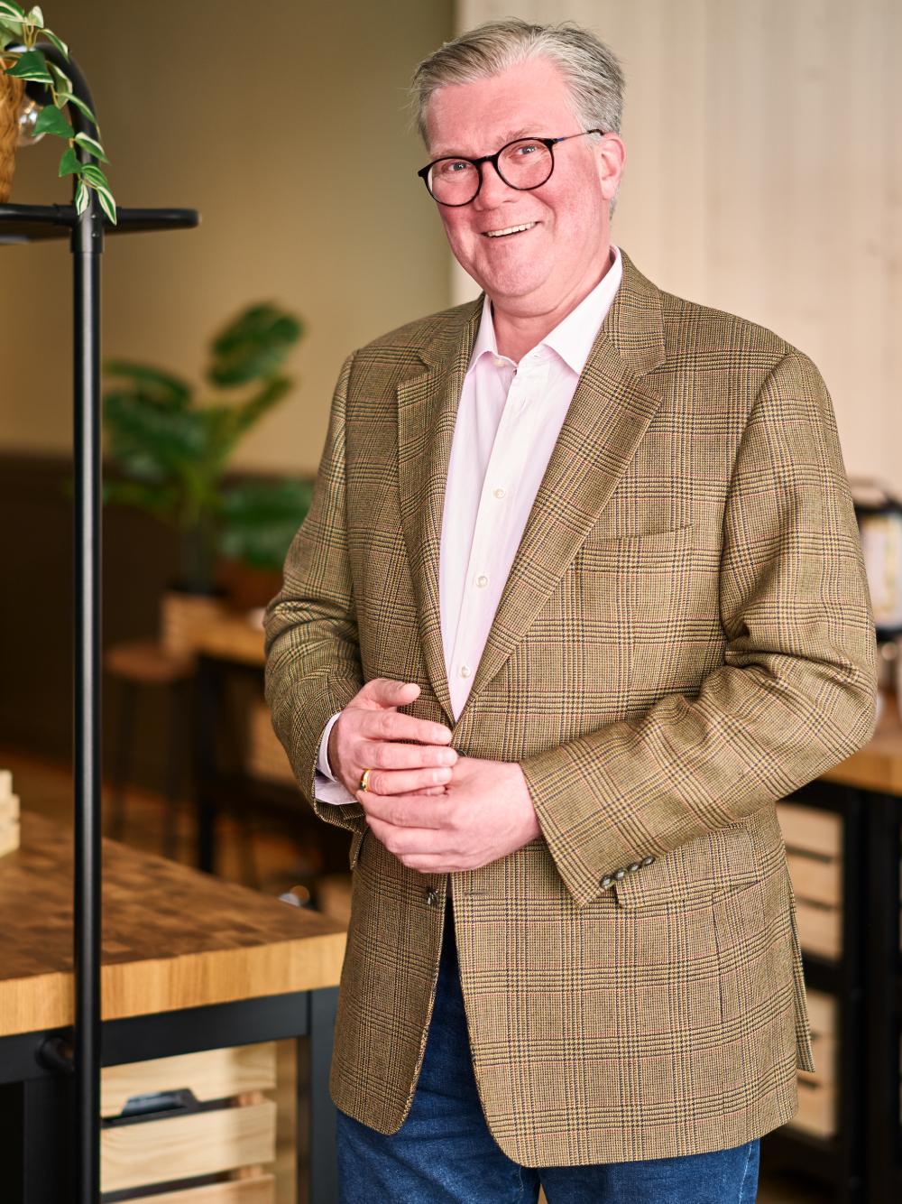 A man in a suit smiling at the camera