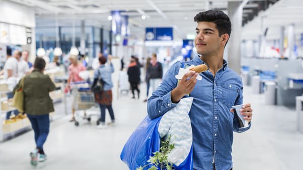 A man in the IKEA store carrying disposable bags