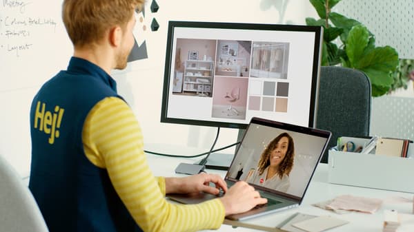A man on a laptop helping a customer