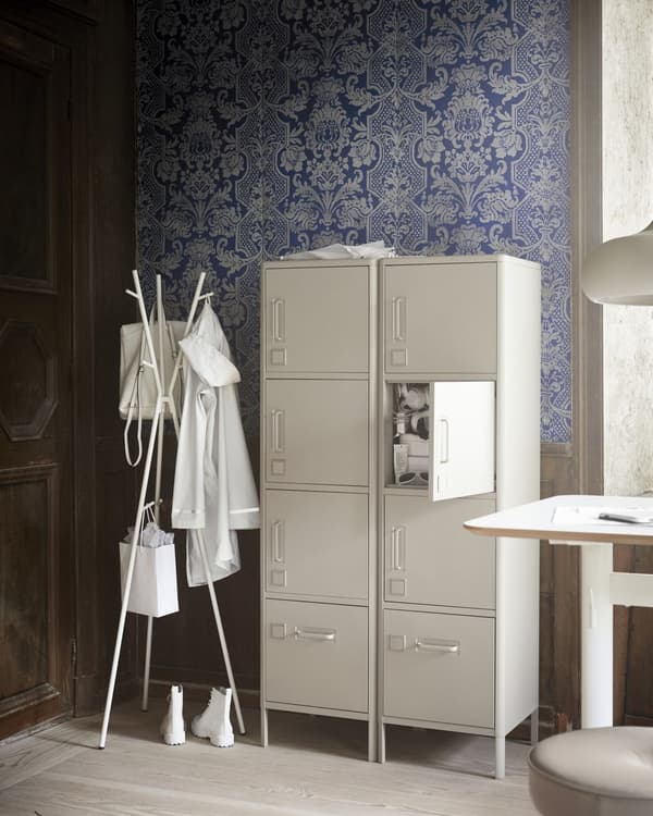 A metal office cabinet in beige with doors