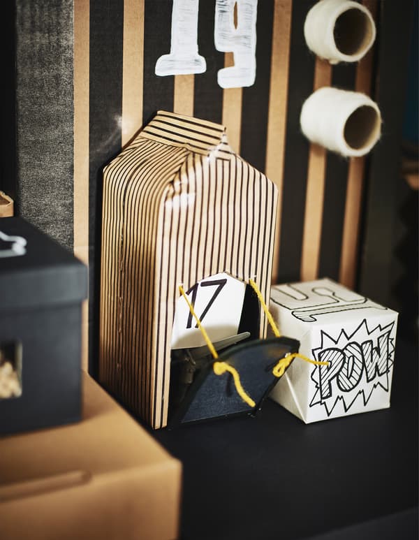 A milk carton wrapped in paper and made to look like a drawbridge castle.