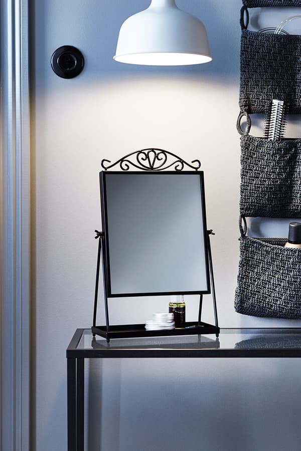 A mirror and a lamp above make a good place for perfecting hair styles