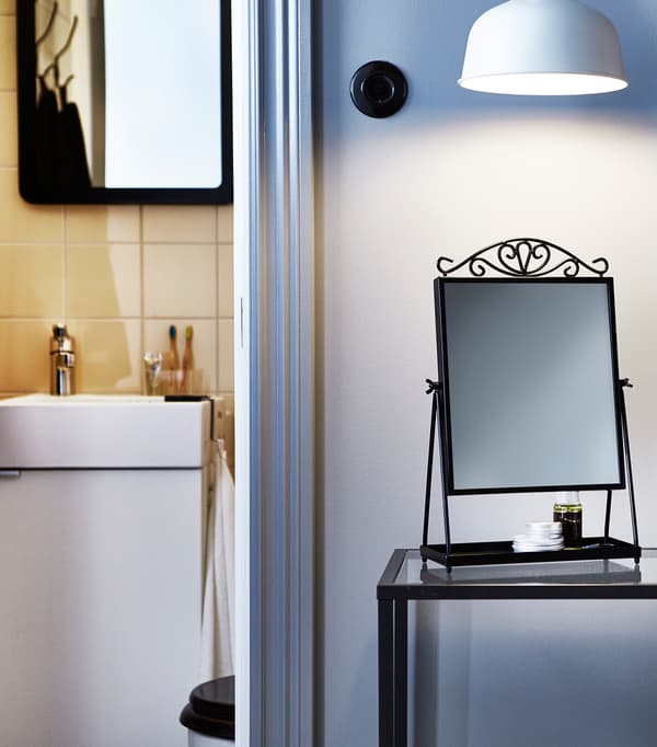 A mirror and a lamp above make a good place for perfecting hair styles.