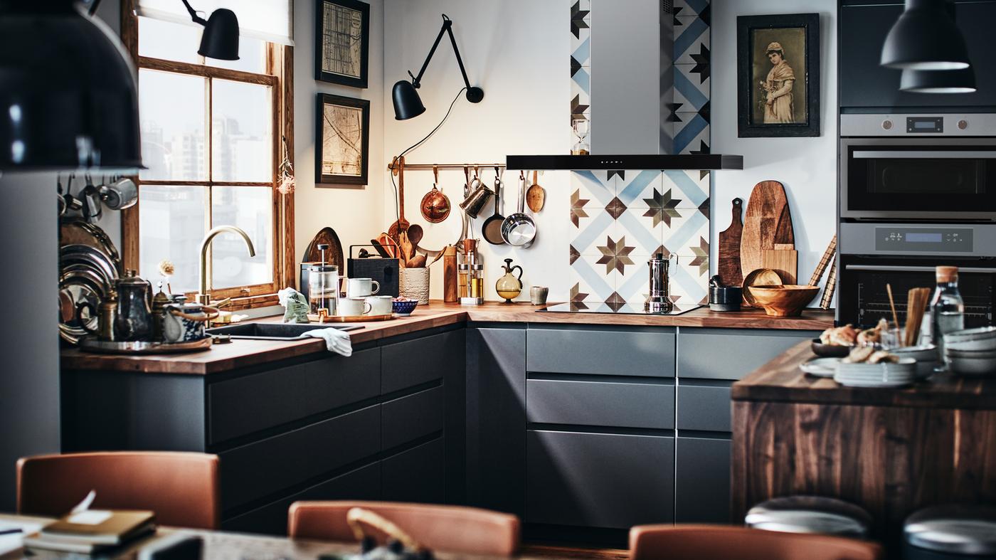 A modern METOD kitchen with dark grey fronts and a wooden worktop with a kitchen tile backsplash.