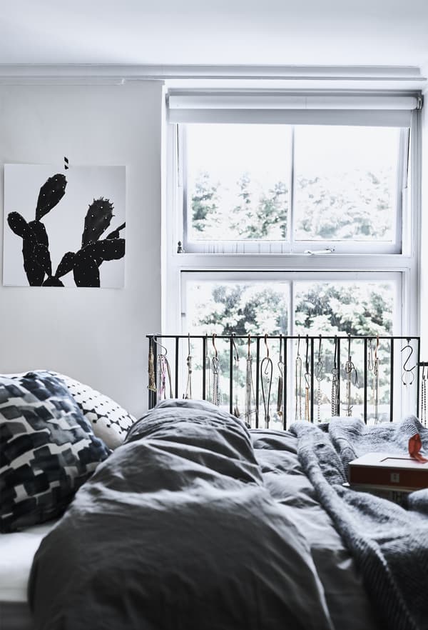 A monochrome bedroom with grey bedding.