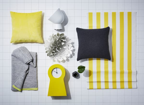 A mood board composed of yellow and black textiles and accessories.