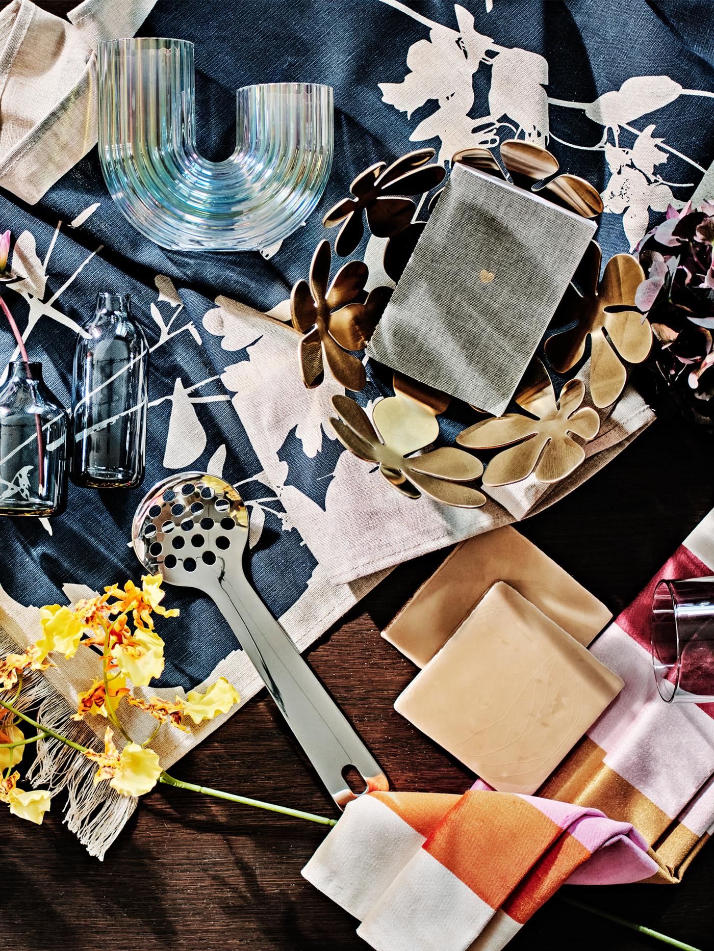 A mood board with a mother-of-pearl colour RÄFFELBJÖRK vase and a gold-colour STOCKHOLM bowl.