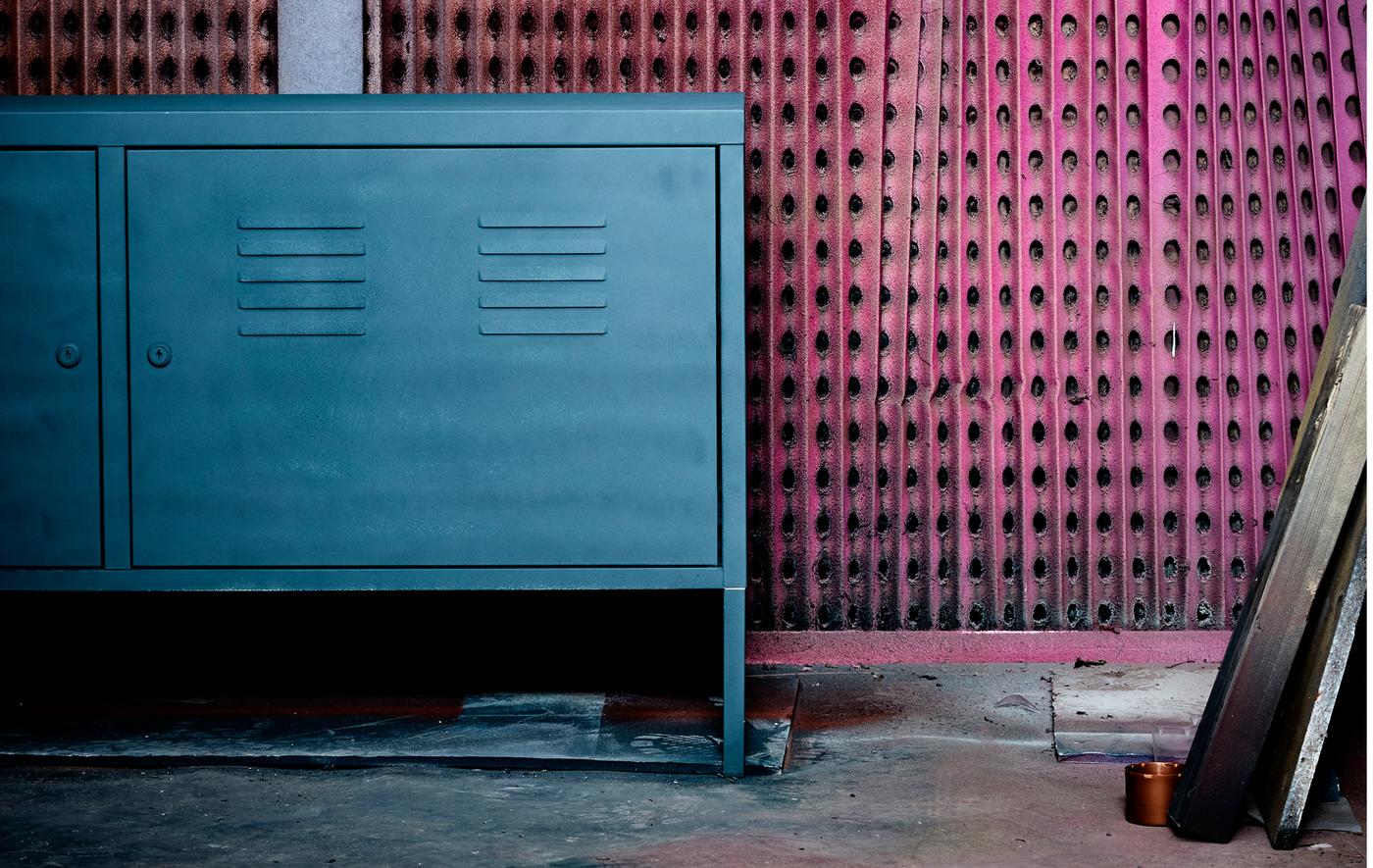 A newly made over metal cabinet sits against a graphically painted wall.
