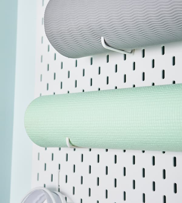 A peg board is the perfect way to store yoga mats, resistance bands, and more.