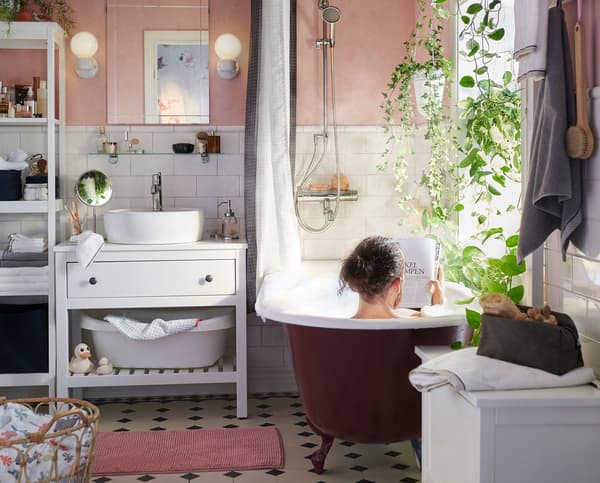 A person reading a magazine in the bath. 