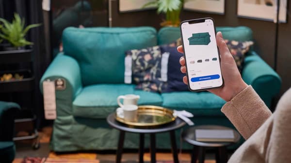 A person using the Afterpay pay app on their phone, while shopping at IKEA.