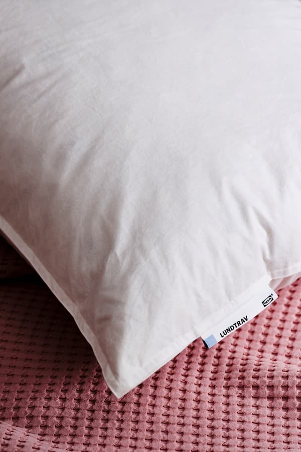 A picture of a feather pillow's edge.