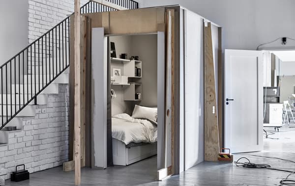 A picture of a small sleeping space next to a staircase in the IKEA Ideas lab, measuring 1.89 square metres in total.