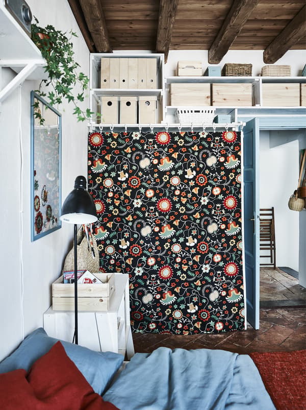 A piece of patterned fabric covering an open wardrobe.
