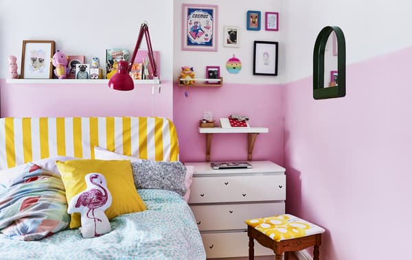 A pink bedroom with yellow accents.