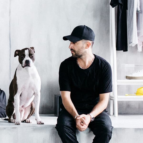 A portrait of a dog and designer Chris Stamp, who created the urban-inspired SPÄNST collection with IKEA.
