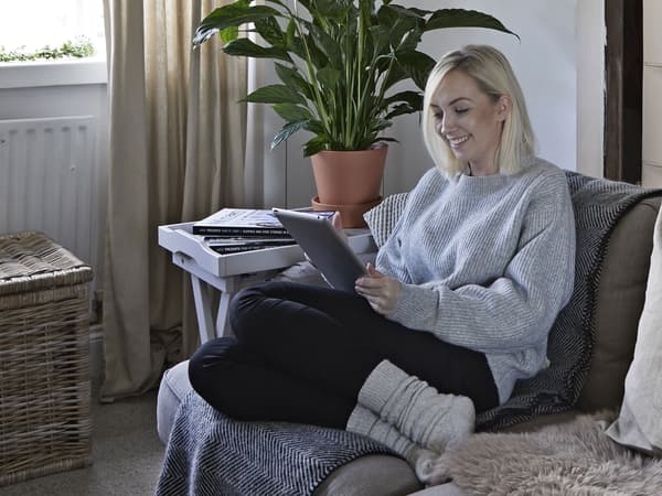 A portrait of Amanda, sitting on a sofa.