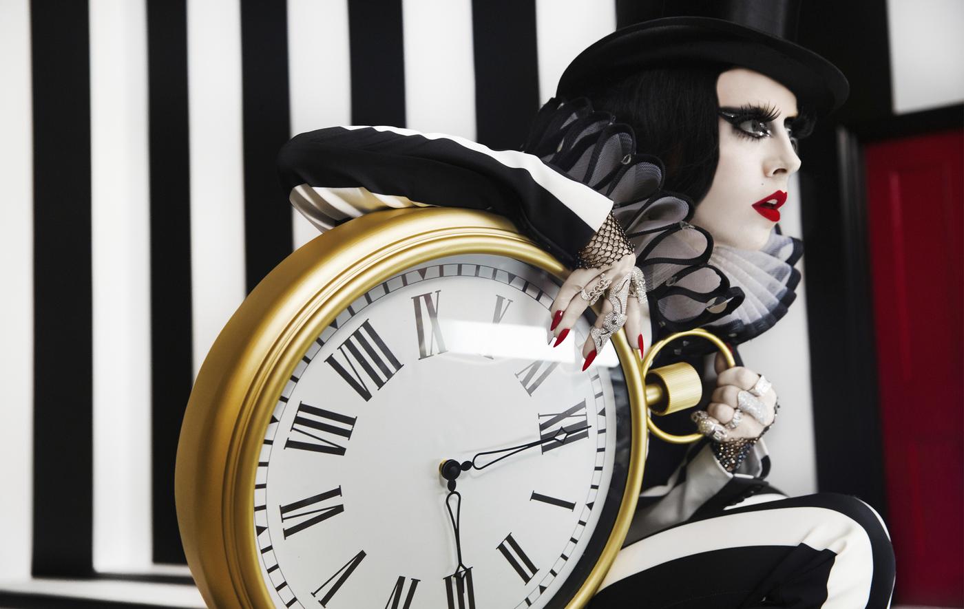 A portrait of Bea Åkerlund posing with wall clock.