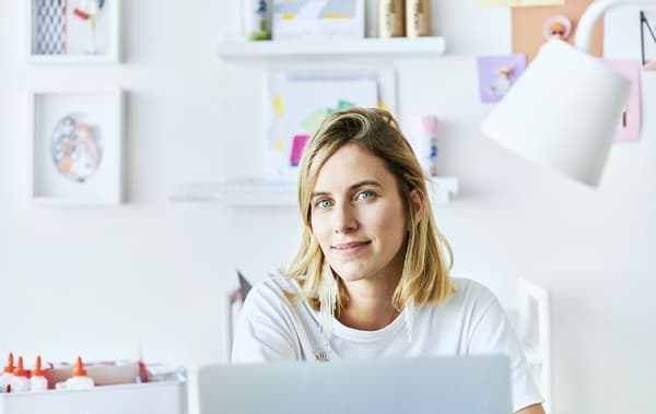 A portrait of Chloé sitting at her desk.