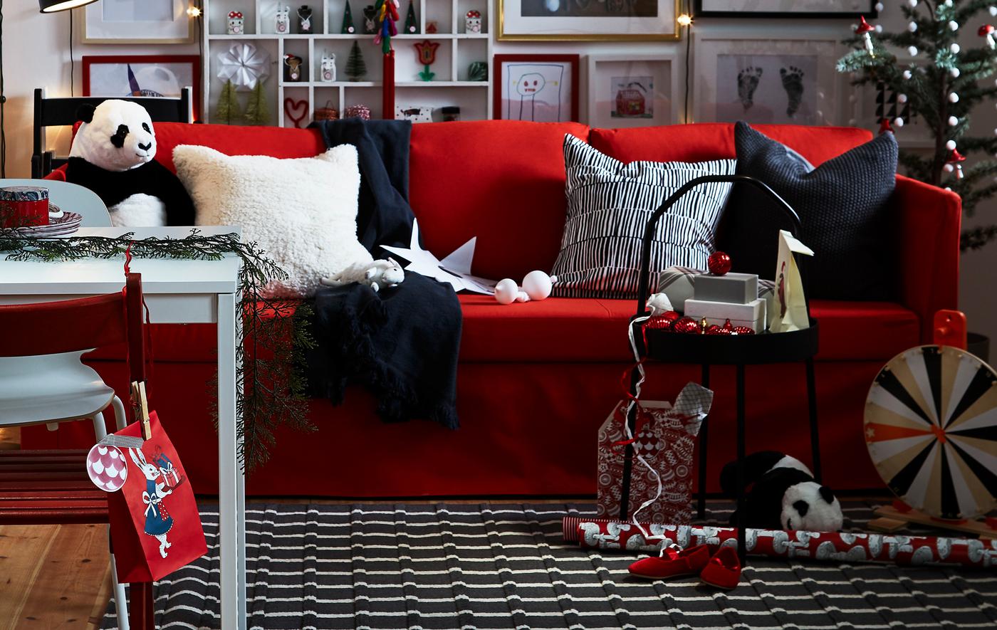 A red, black and white living room with festive decorations.