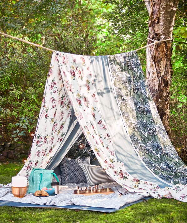 A rope between two trees and long pieces of fabric like multicoloured EMMIE ROS make a summer tent for picnics.