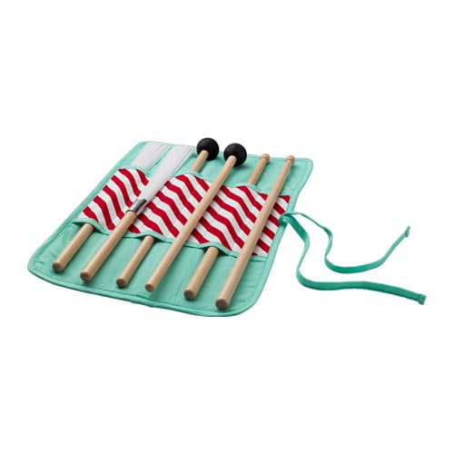 A set of drumsticks in a light green holder against a white background.