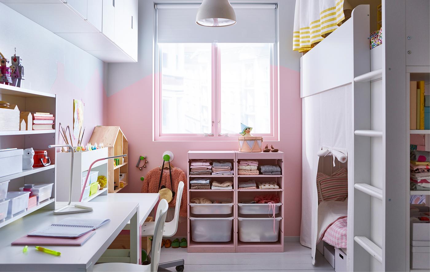 A shared kids’ room with a loft bed, storage and two desks.