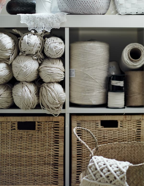 A shelving unit and drawers filled with thread.