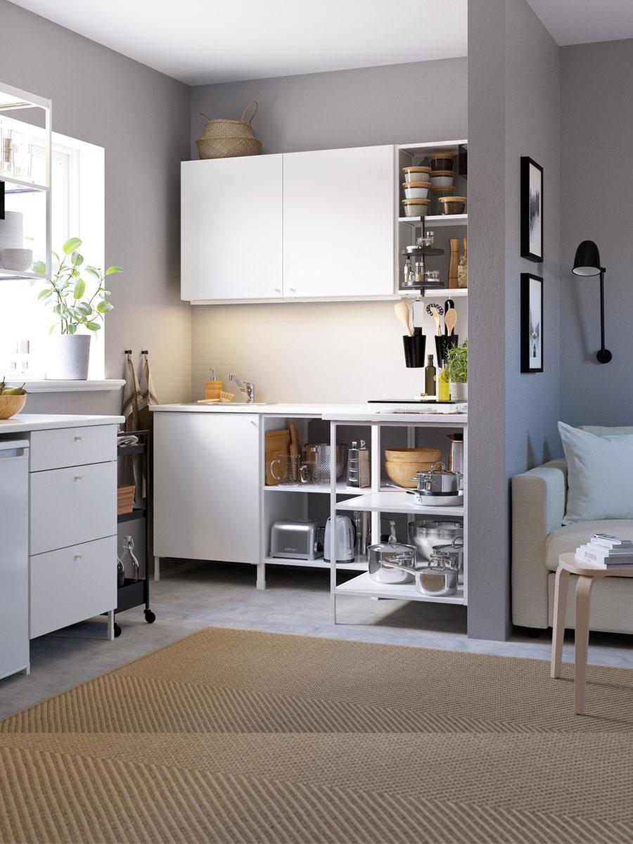 A small living space featuring a a kitchen with many accessories kept in the storage.