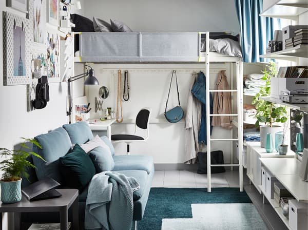 A small one-bedroom-apartment that's grey, green and white and has a loft bed that has a desk under it.