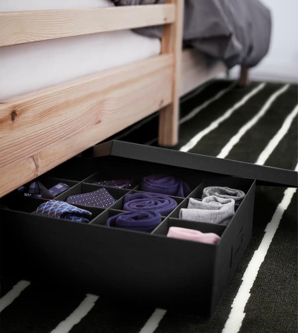 A small space organisation tip for your dorm room is to use all your space. Under your bed, put a TJENA box with compartments for socks and small accessories. IKEA has a wide selection of storage boxes in different colours and sizes to sort your stuff.