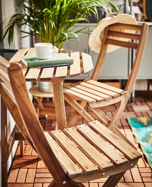 A small table and two foldable chairs create an intimate seating area.