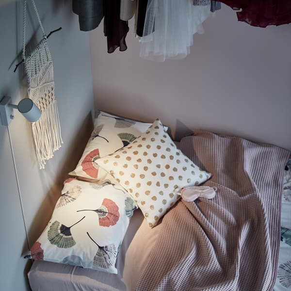 A sofa bed with IKEA SKÄGGÖRT cushions scattered as pillows.