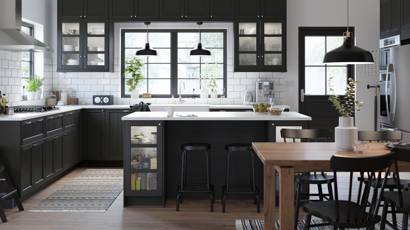 A spacious black and white kitchen in a classic style with stained black LERHYTTAN cabinet doors.