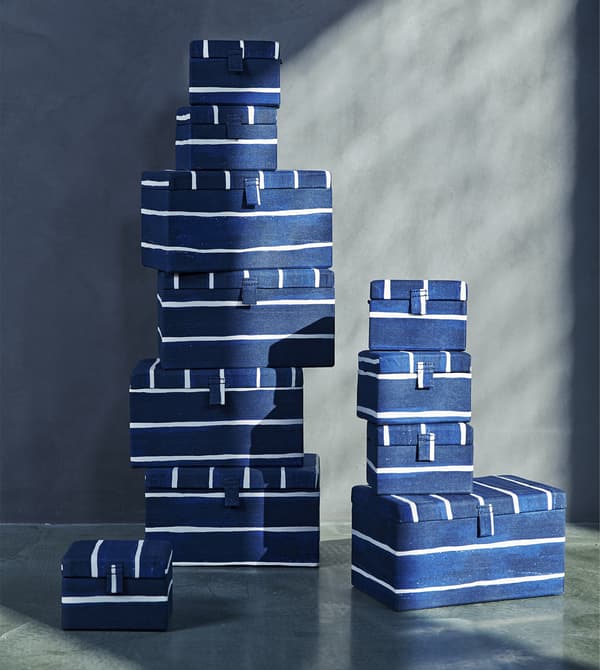 A stack of blue-and-white striped storage boxes.