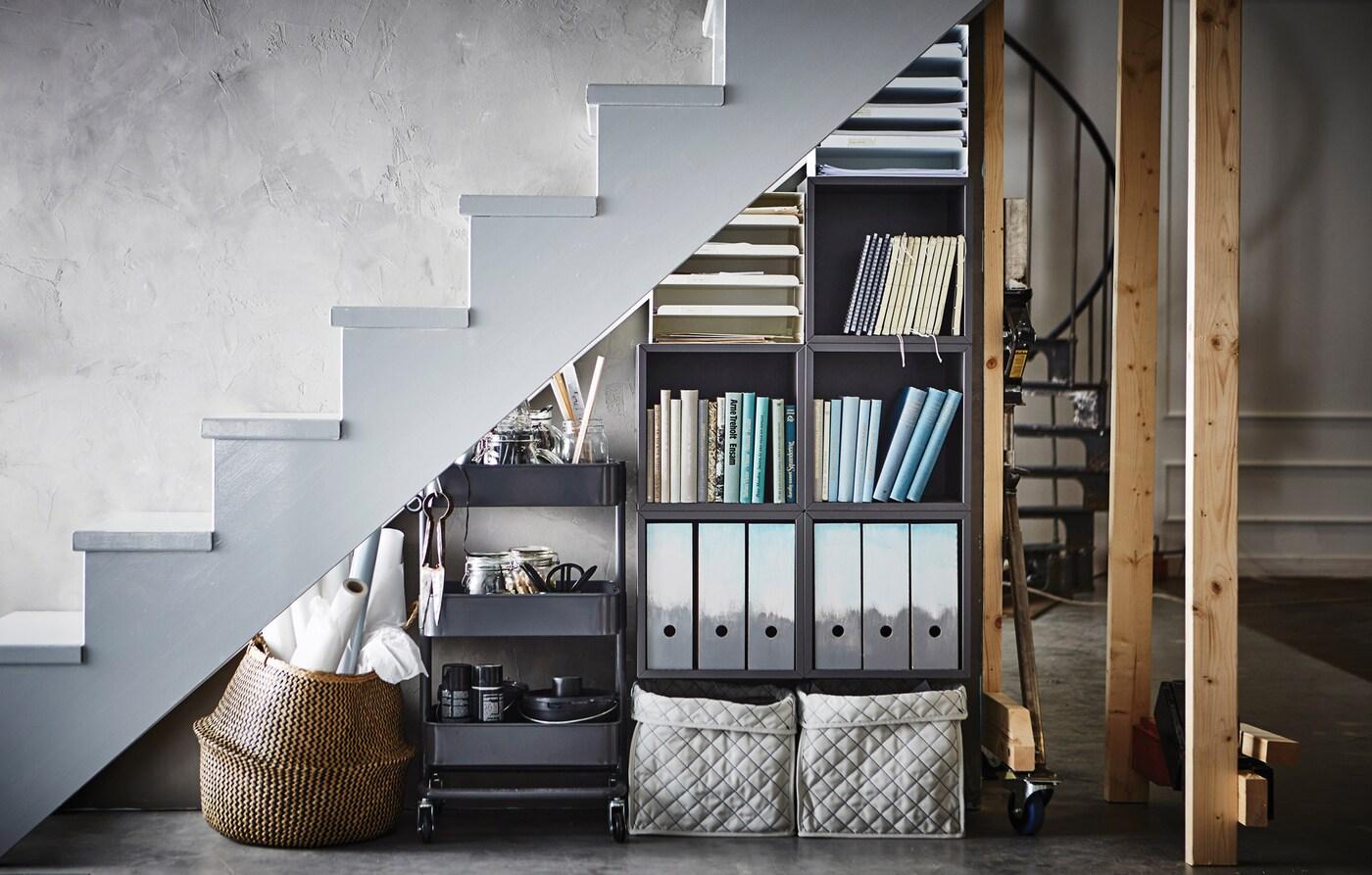 A storage under the stairs with KALLAX and a RASKOG trolley.