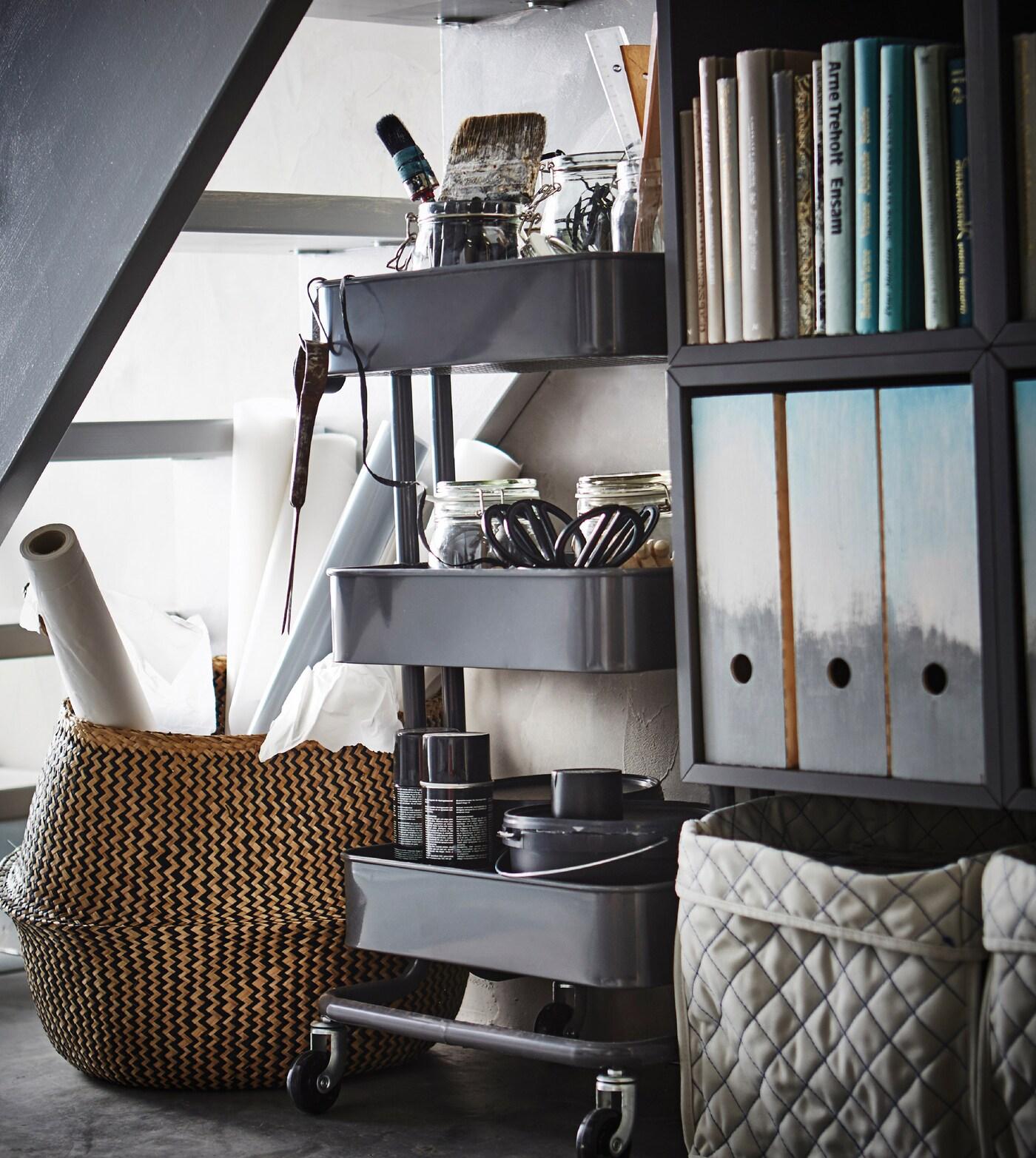 A storage under the stairs with KALLAX and a RASKOG trolley.