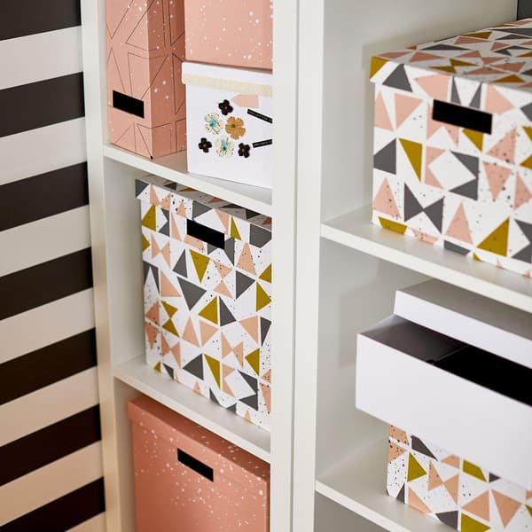 A storage unit with decorative storage boxes with lids.