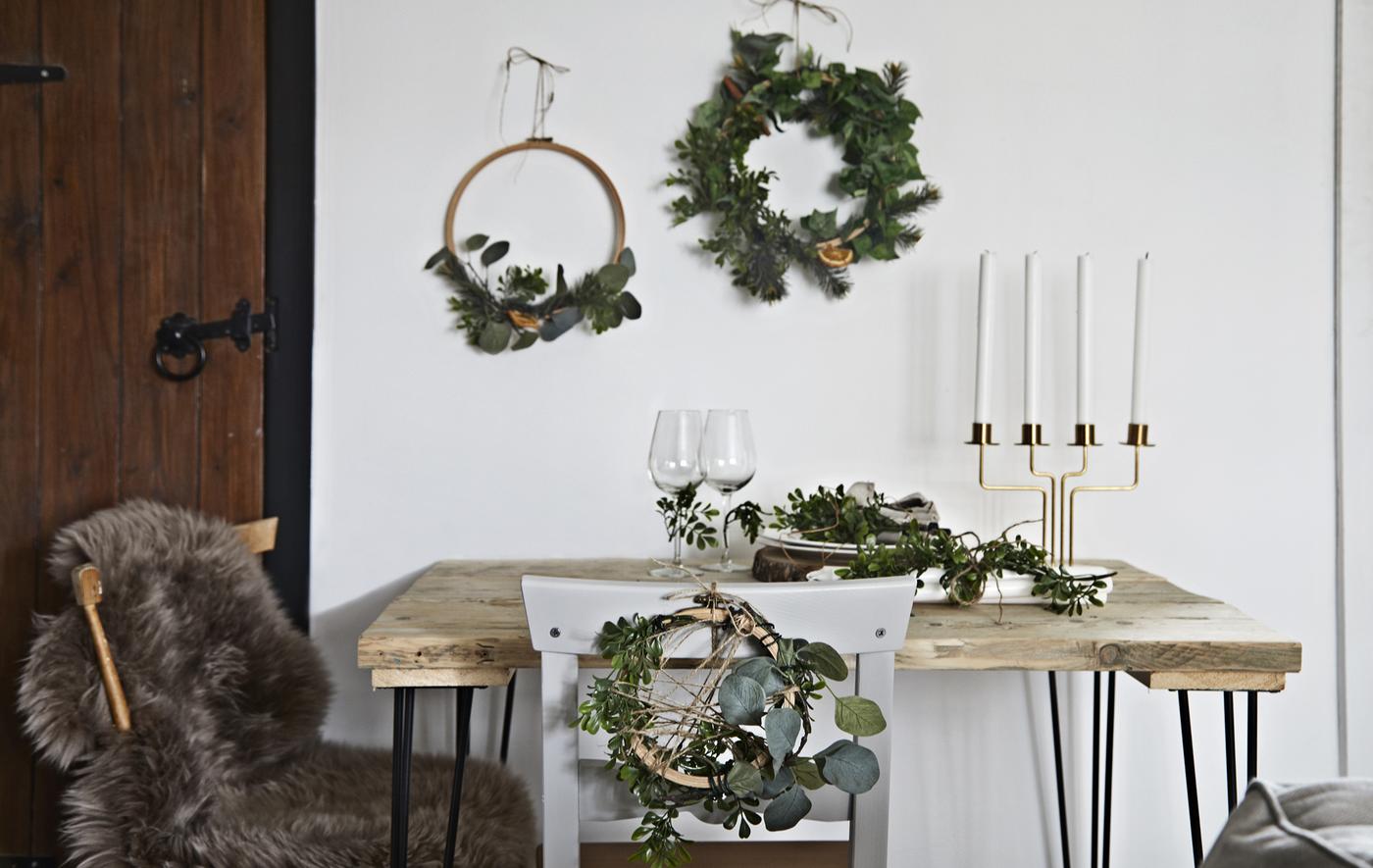 A table decorated with festive wreaths and accessories.