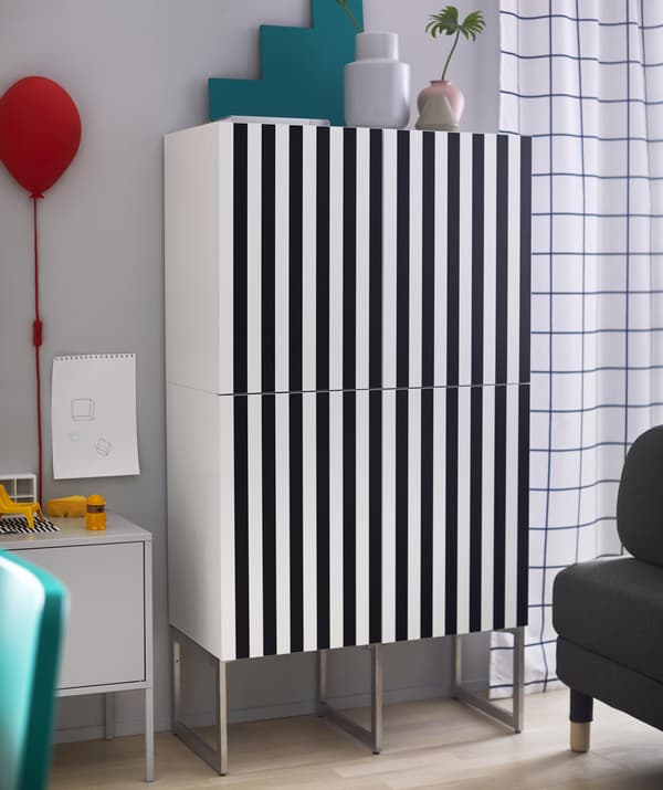 A tall cupboard with striped black and white front.