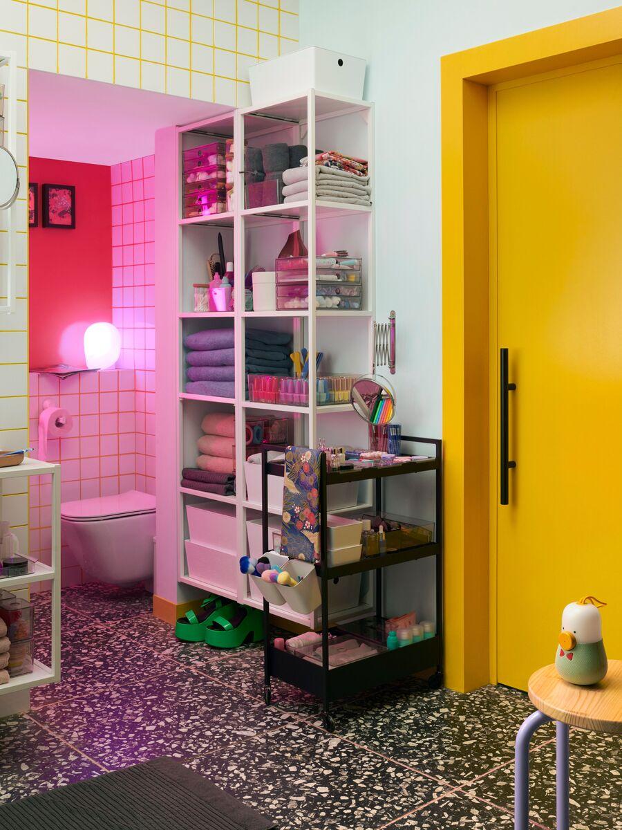 A toilet where you see a large round mirror right in front and a shower/toilett to the left.