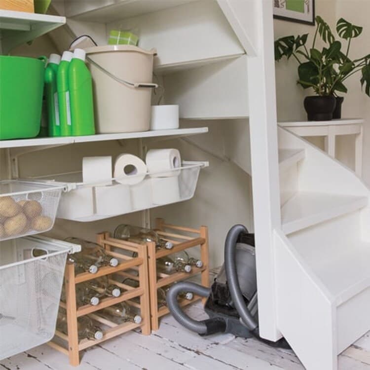 A tricky corner of the under-stairs cupboard is the perfect storage spot for your vacuum cleaner and wine bottles.