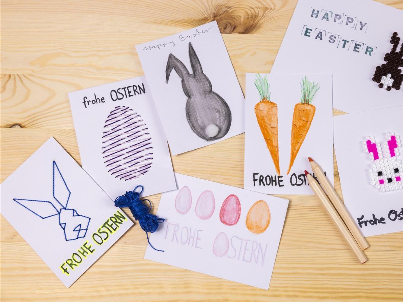A variety of homemade Easter cards, made from SOLFÅGEL paper and embroidered with Easter designs, either hand-drawn or decorated with iron-on beads.