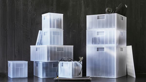 A variety of PANSARTAX storage boxes from small to large with different items such as clothing items, toys and others organised neatly inside.