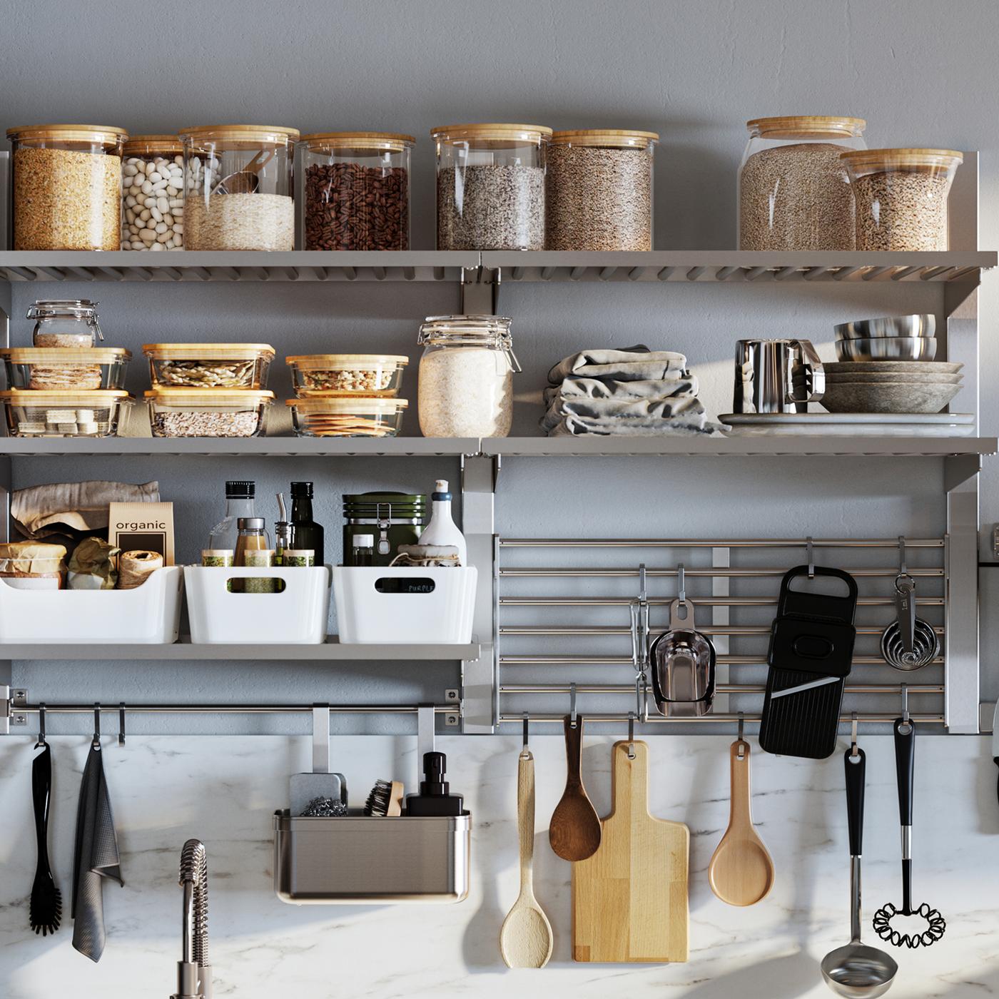 A wall-mounted KUNGSFORS kitchen storage series with glass jars with lids, white VARIERA storage boxes and hanging utensils.