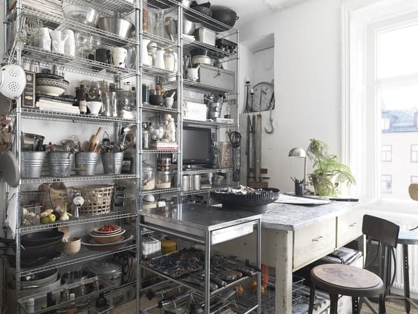 A wall of metal open storage in a kitchen.
