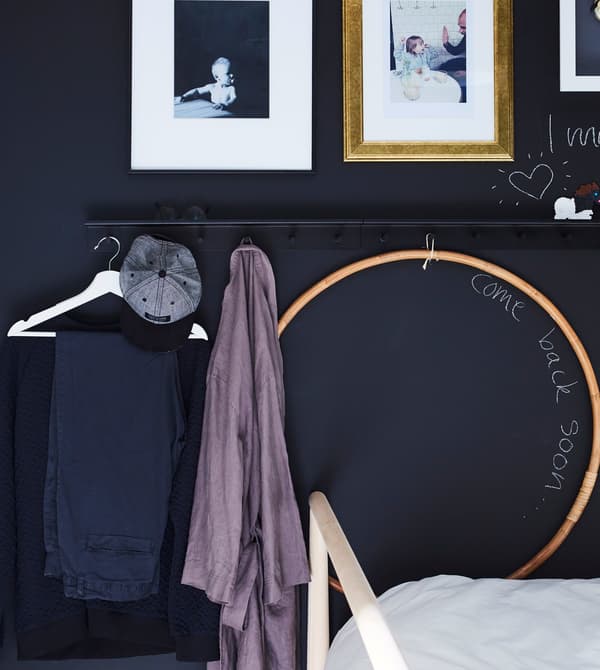 A wall rail with hooks and the next day’s outfit hung on a clothes hanger on the rail.