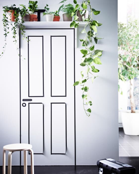 A wall shelf placed over a door is a great place to display trailing plants like ivy. 