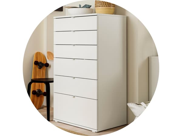 A white 6-drawer dresser with a black-brown stool next to it.